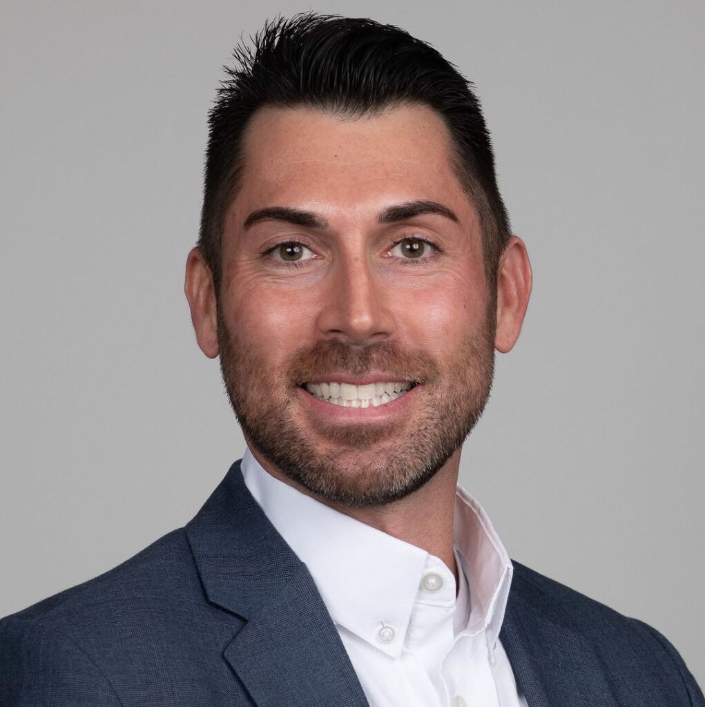 Professional LinkedIn headshot of a man in a suit.
